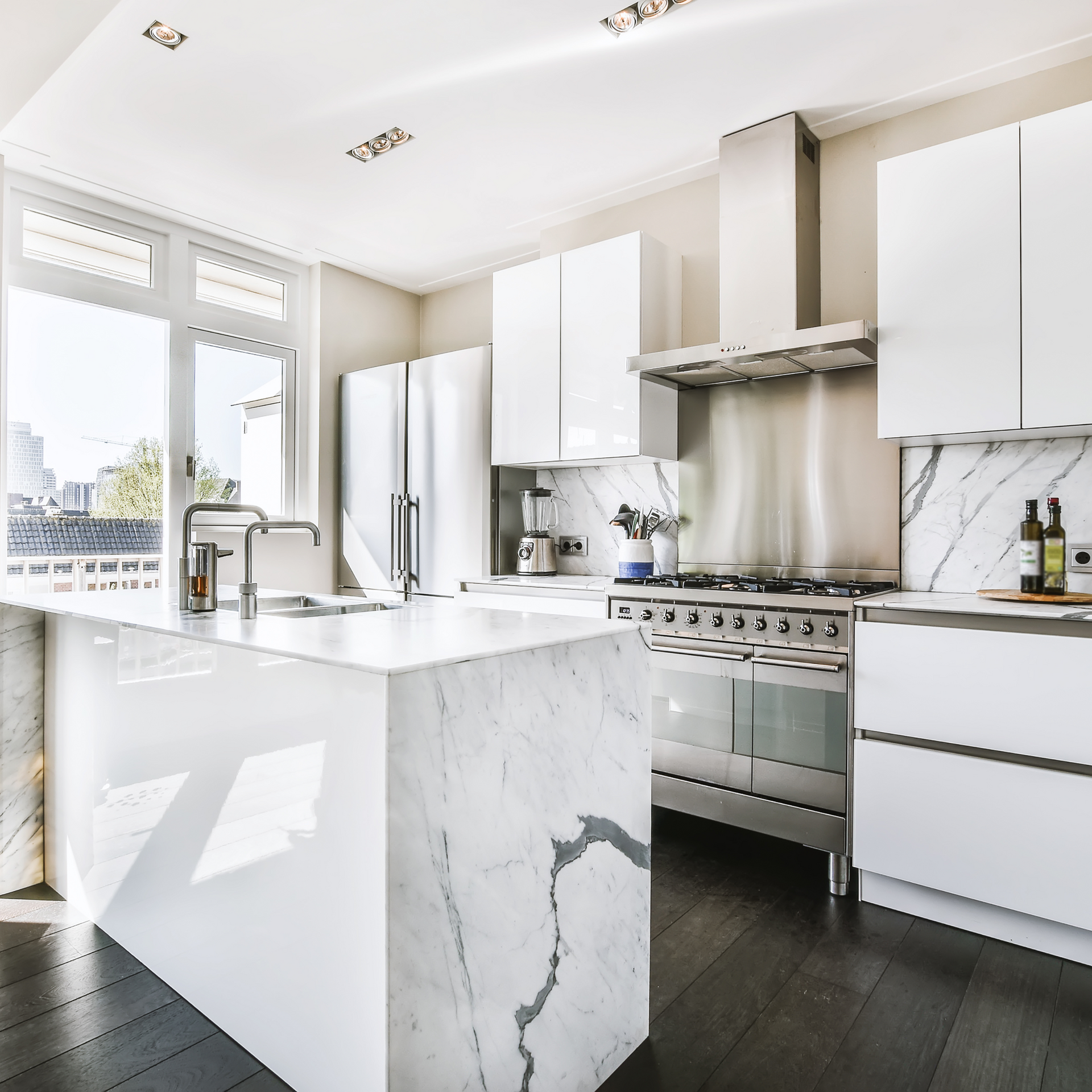 A kitchen with white cabinets and stainless steel appliances
