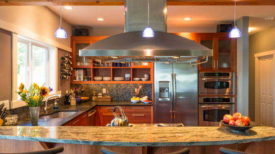 A kitchen with stainless steel appliances and a stove top oven.