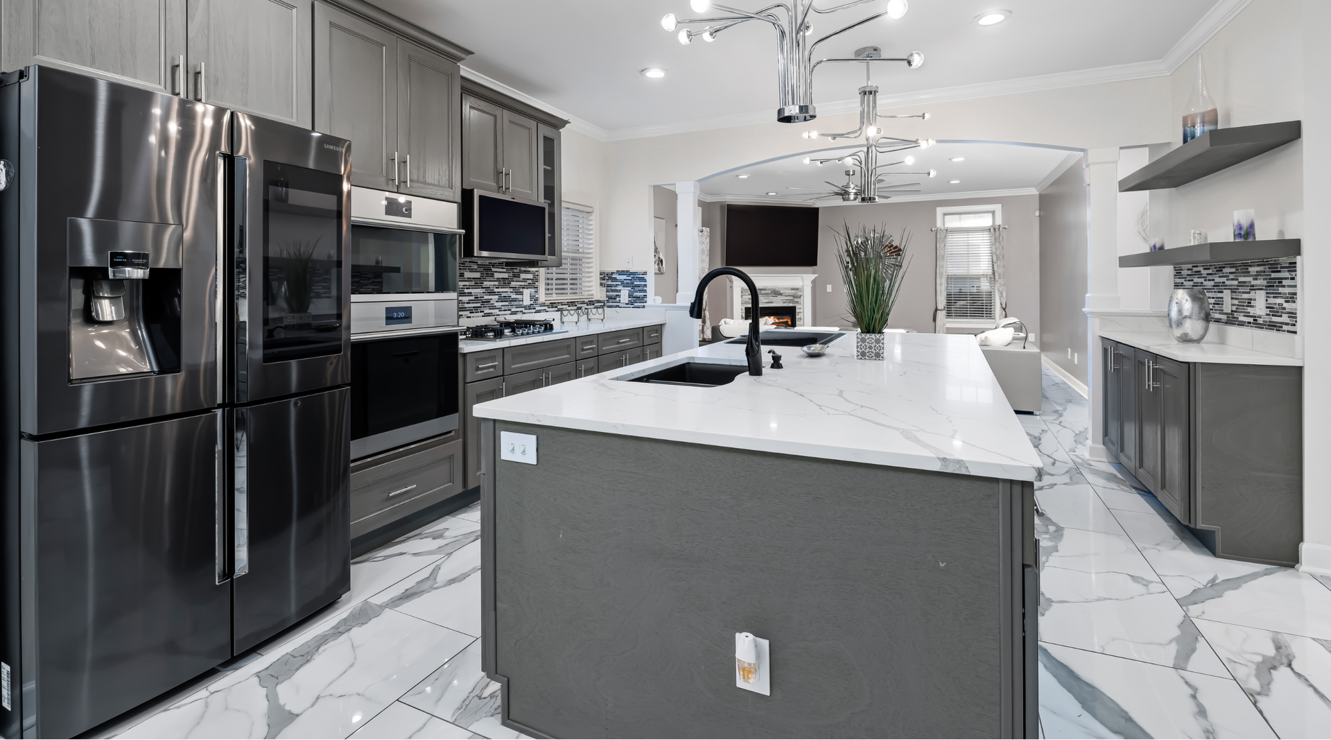 A kitchen with a large island and stainless steel appliances.