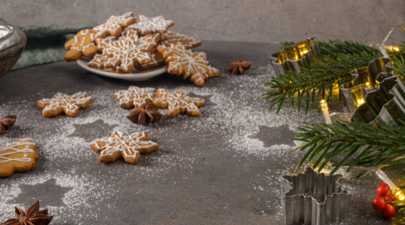 A table topped with gingerbread cookies and christmas decorations.