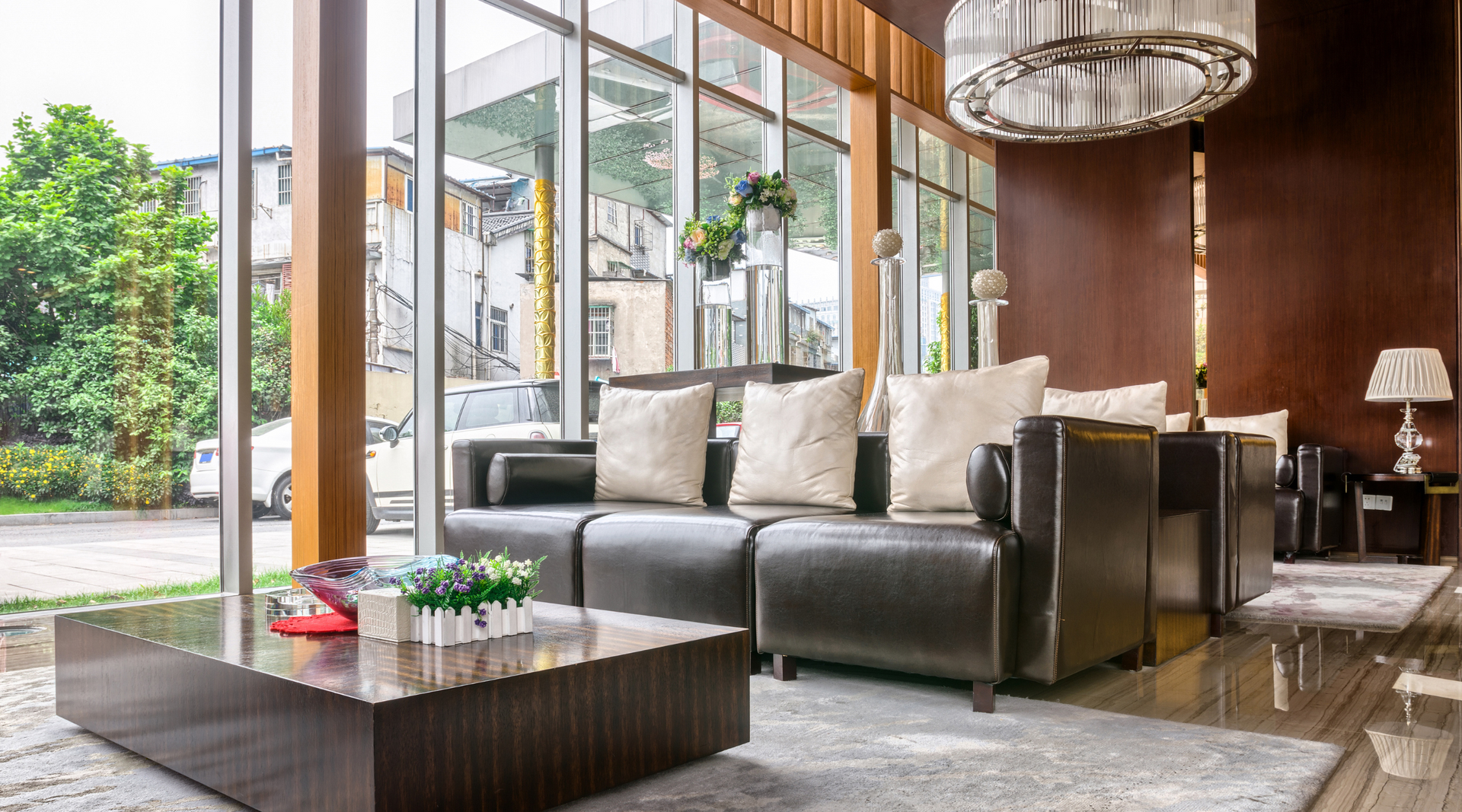 A living room with a couch , chairs , and a coffee table.