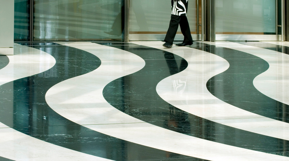 A person is walking on a black and white striped floor