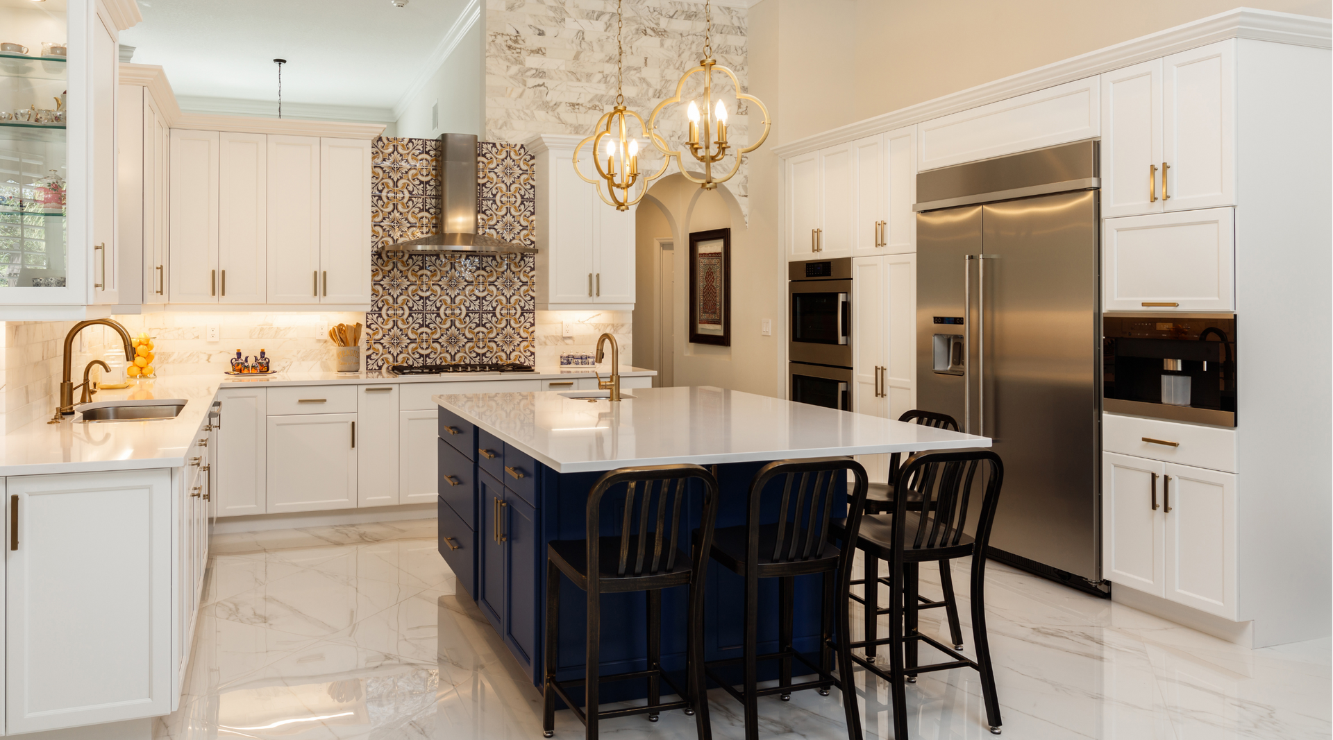 A kitchen with white cabinets , stainless steel appliances , and a large blue island.