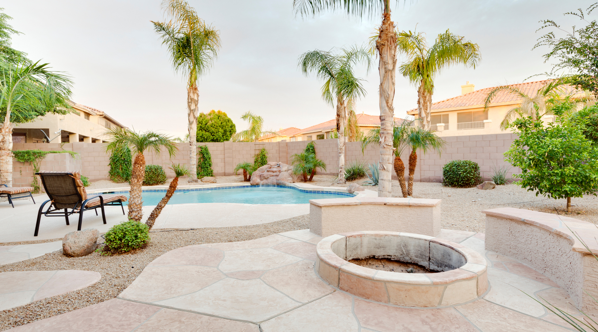 There is a fire pit in the middle of the backyard.
