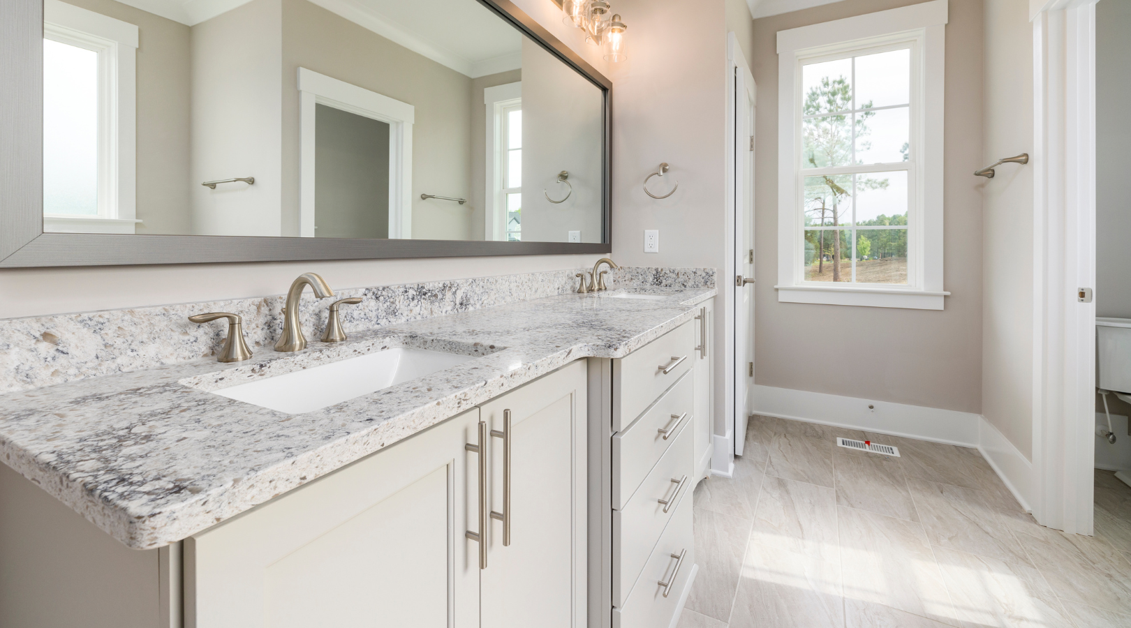 A bathroom with two sinks and a large mirror.