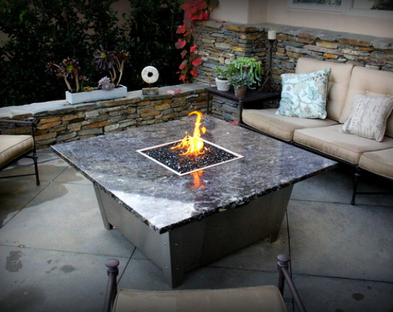 There is a fire pit in the middle of the table.