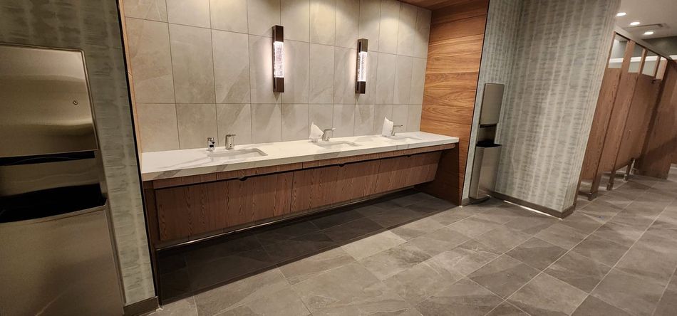A bathroom with a lot of sinks and toilets.
