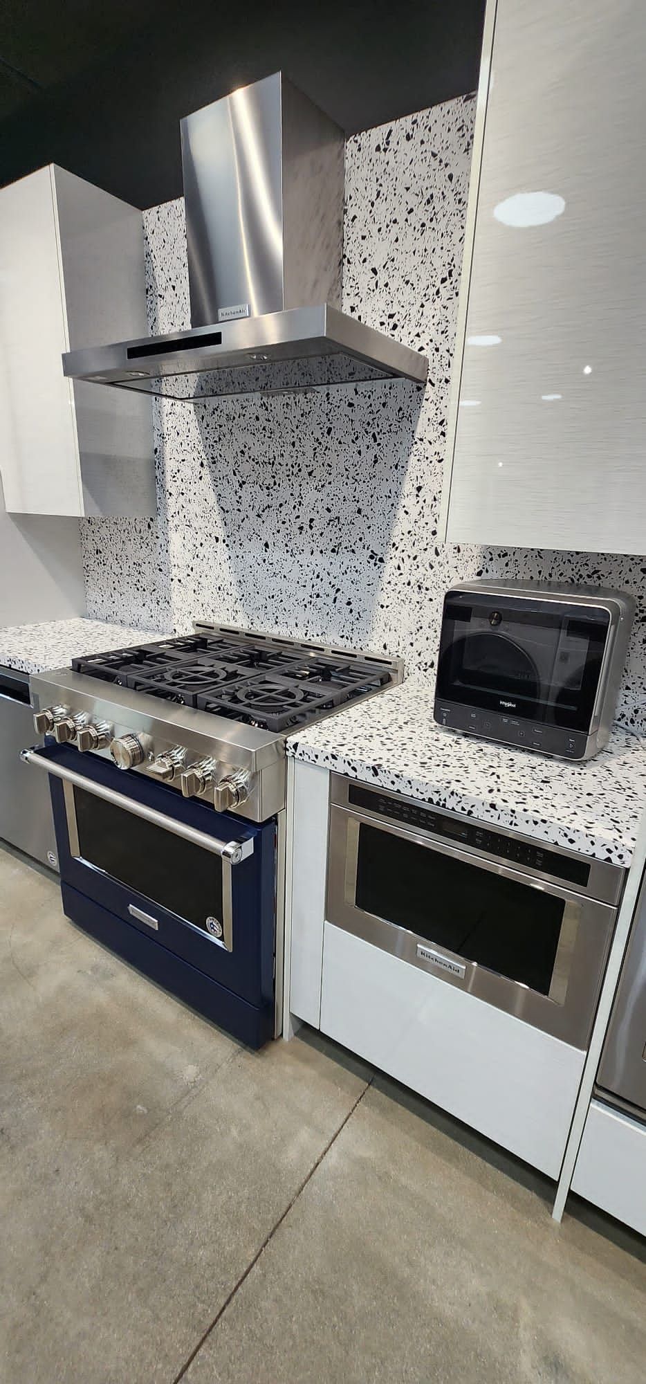 A kitchen with a stove and a microwave in it.