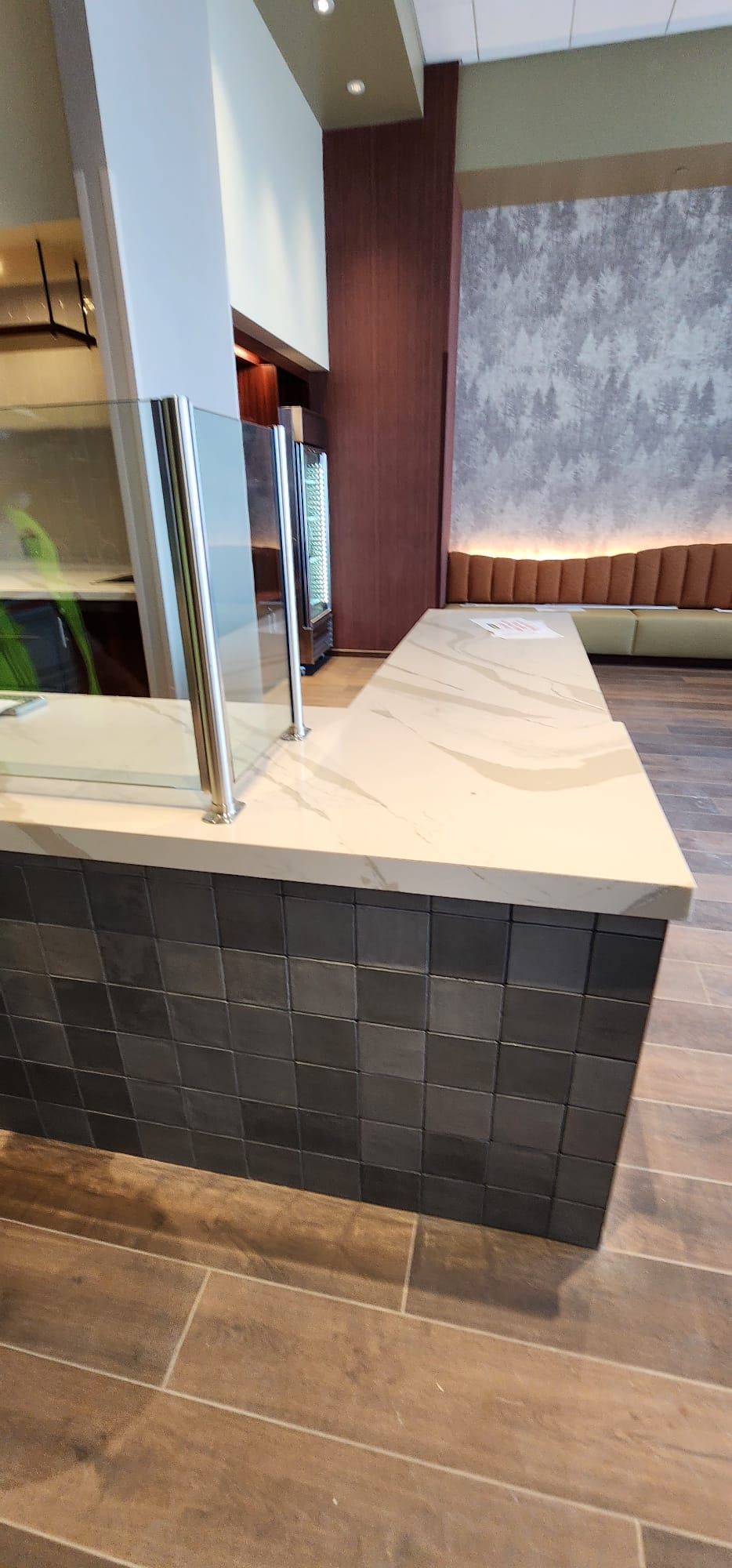 There is a counter in the middle of the room with a glass divider.