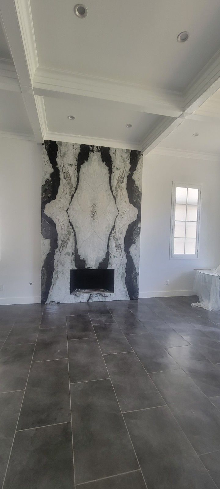 There is a fireplace in the middle of the room.