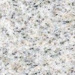 A close up of a white granite counter top.