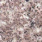 A close up of a pink granite counter top.