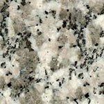 A close up of a granite counter top with black and white spots.