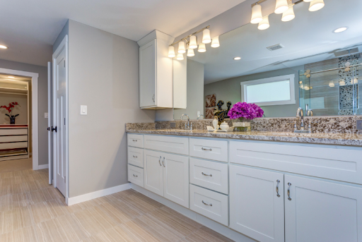 A bathroom with two sinks and a large mirror.