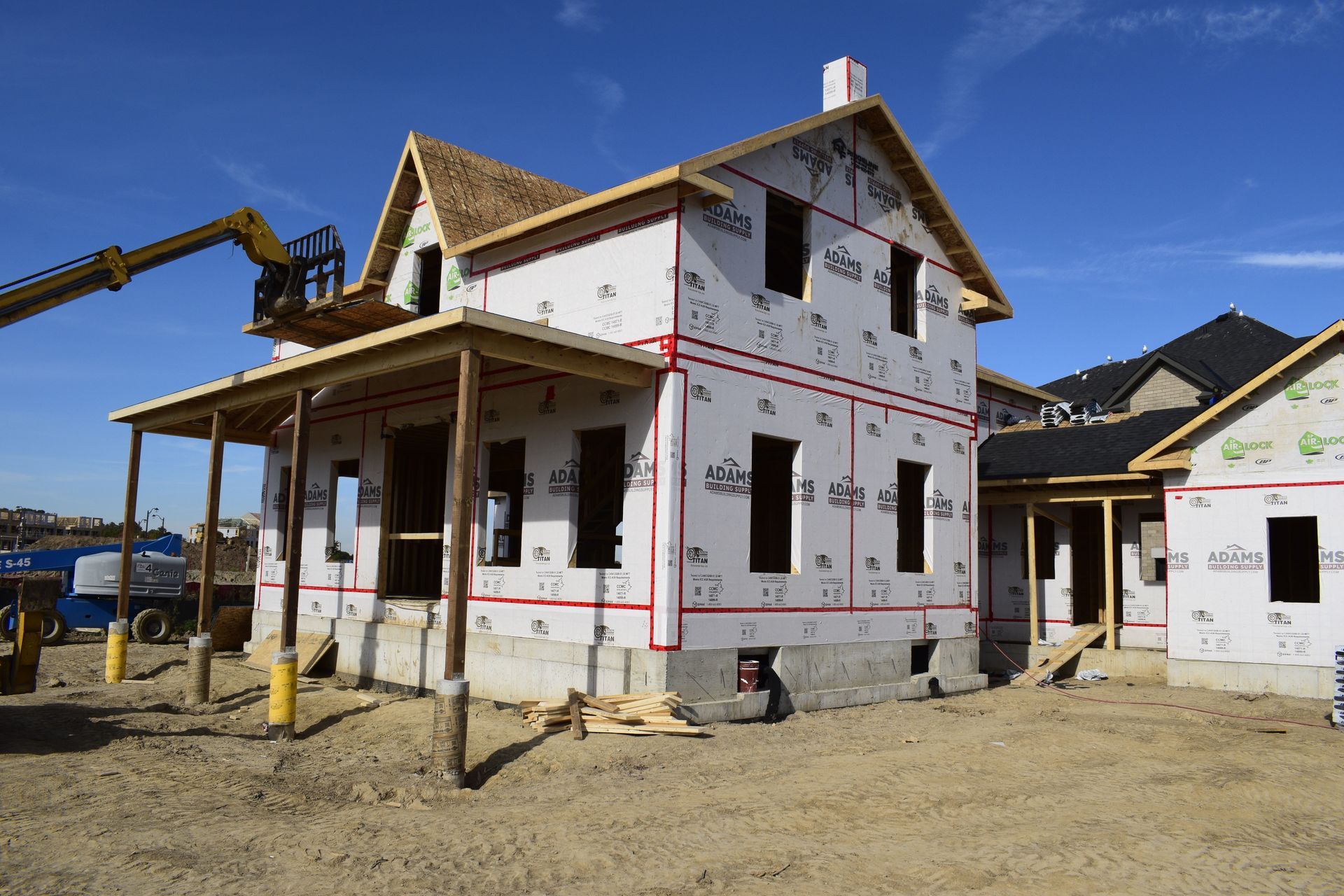 Gothic revival farmhouse under construction with rear addition and updated front porch 
