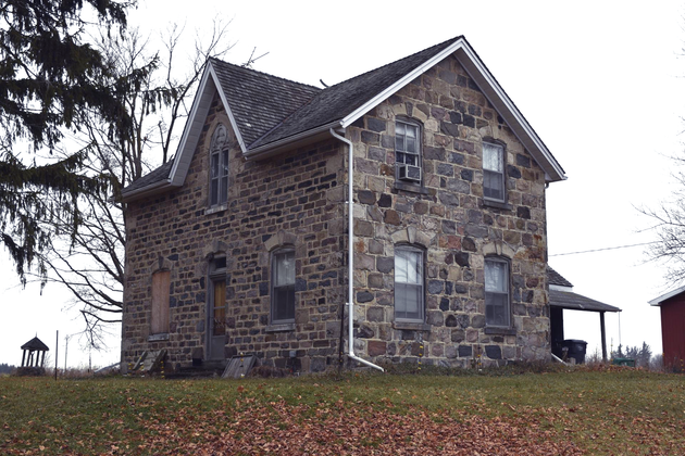 Gothic revival farmhouse with stone exterior