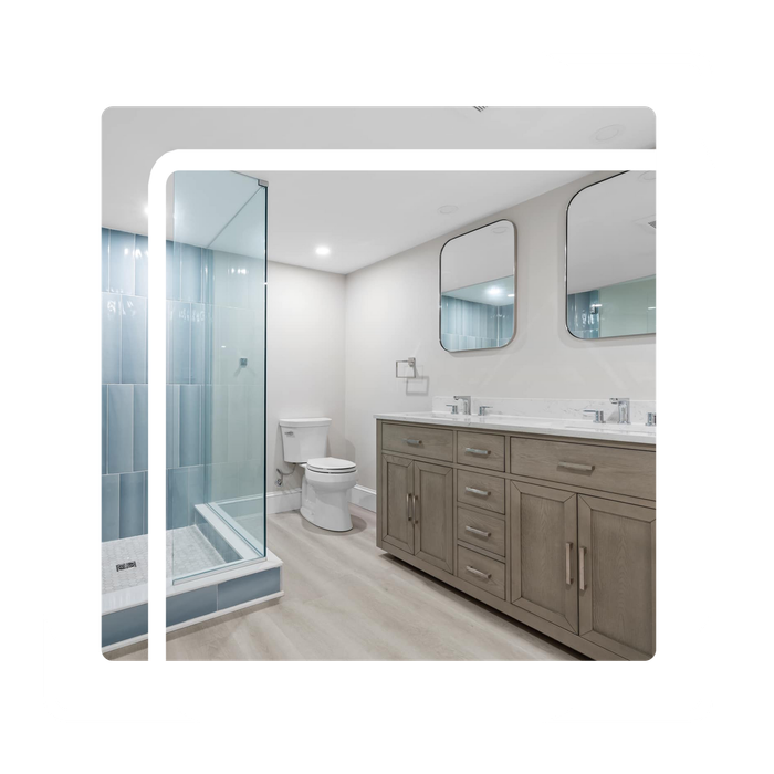 A bathroom with two sinks , a toilet , and a walk in shower.