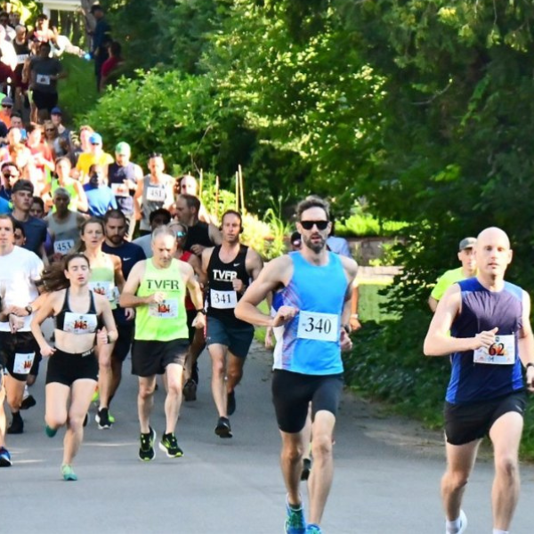 A group of people are running a race and one of them has the number 340 on his shirt