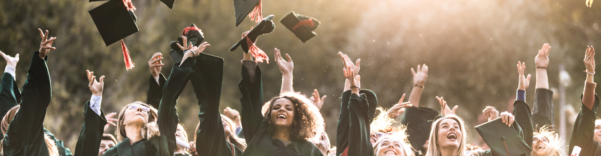Graduation-themed graphic with a black mortarboard on top of books. The words 