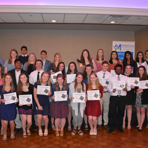 A group of people posing for a picture holding certificates