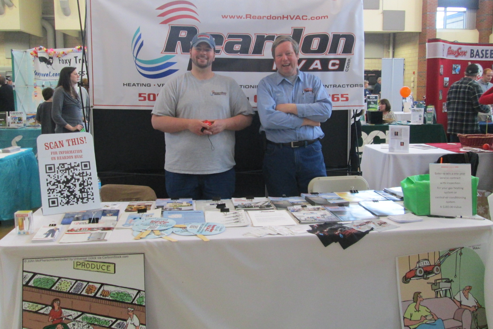 Two men standing in front of a sign that says rearton vac