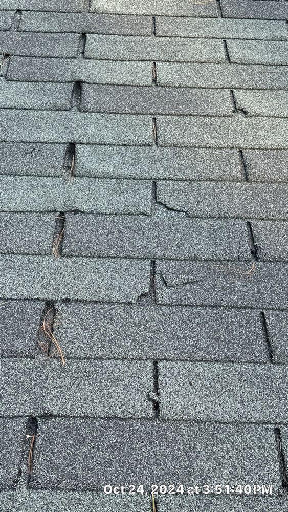 A close up of a roof with a lot of shingles missing.