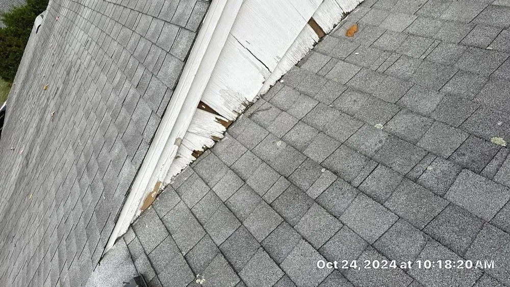A close up of a roof with a gutter on it.