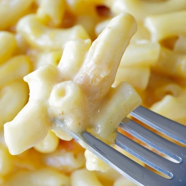 A close up of macaroni and cheese with a fork