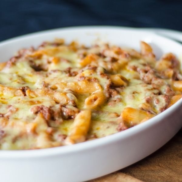 A white casserole dish filled with meat and cheese