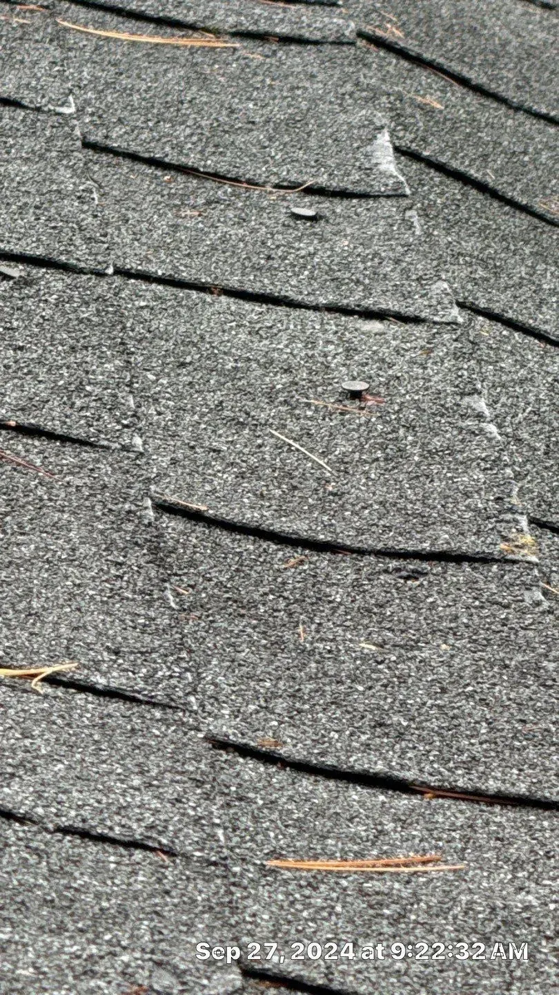 A close up of a roof with a lot of shingles on it.