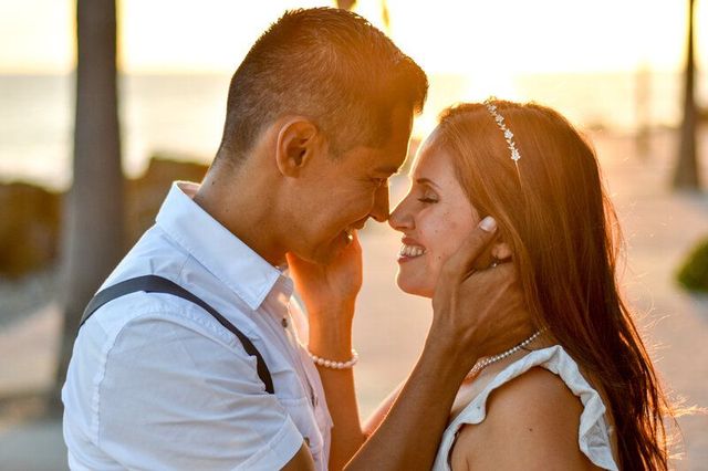 A man and a woman are looking into each other 's eyes at White Point Beach.