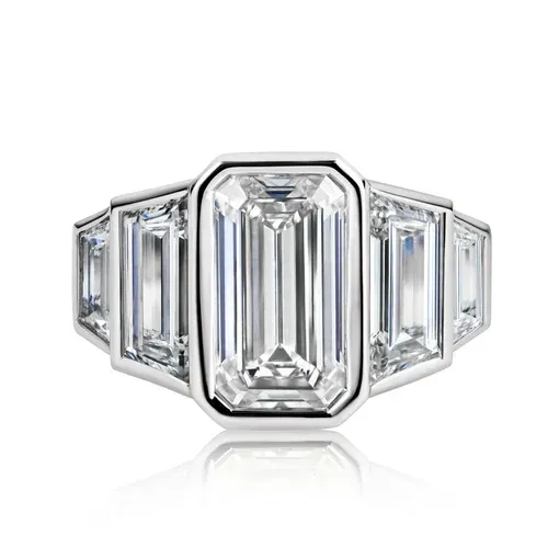 Emerald-cut diamond ring with baguette side stones in a silver setting