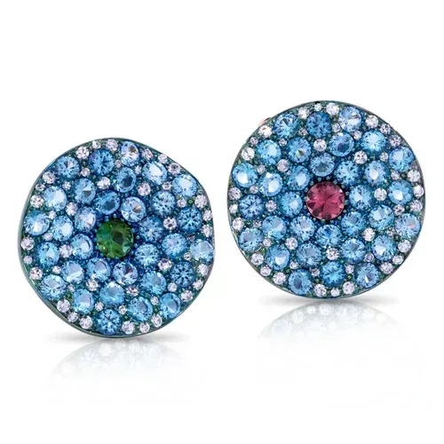Two jeweled circular earrings with blue stones and green or pink center gems on a white background Two jeweled circular earrings with blue stones and green or pink center gems on a white background