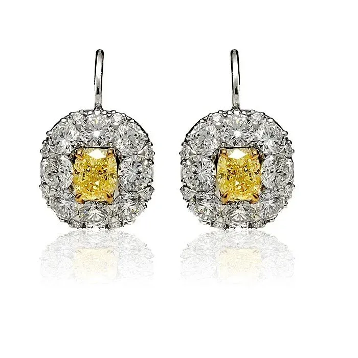 Pair of silver and yellow gemstone drop earrings on a white background