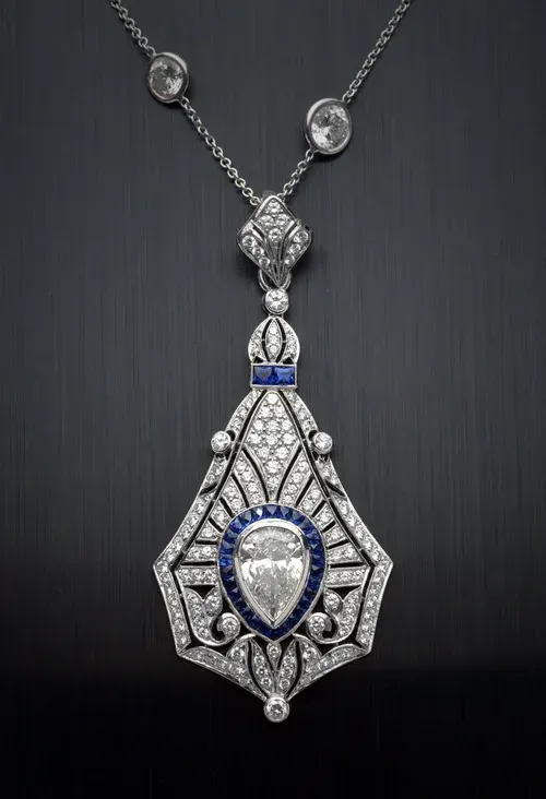 Silver and blue ornate pendant necklace on a dark background Silver and blue ornate pendant necklace on a dark background