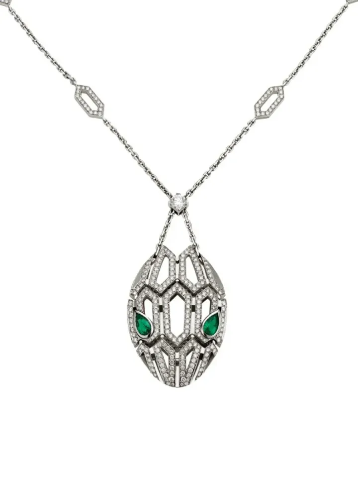 Silver pendant necklace with a geometric owl-shaped charm and green accents