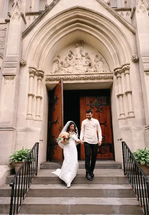 Bride and groom walking down church steps after a wedding ceremony Bride and groom walking down church steps after a wedding ceremony