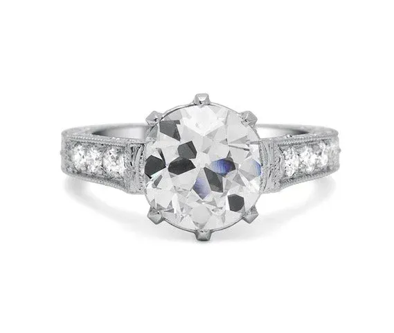 White gold ring with oval clear gemstone and pavé diamond band