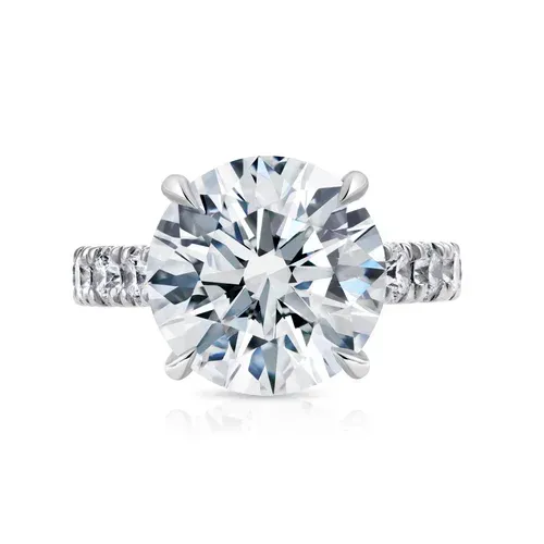 Round diamond solitaire ring with a silver band and pavé setting Round diamond solitaire ring with a silver band and pavé setting