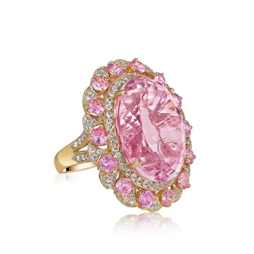 Pink oval gemstone ring with gold setting and pink accent stones Pink oval gemstone ring with gold setting and pink accent stones
