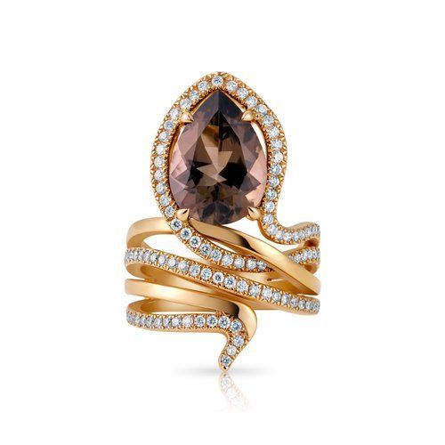 Gold snake ring with a pear-shaped brown gemstone and small clear stones on a white background
