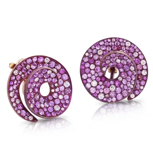 Pair of purple gemstone spiral earrings on a white background Pair of purple gemstone spiral earrings on a white background