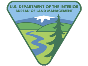 U.S. Department of the Interior Bureau of Land Management logo with mountains, river, and pine tree