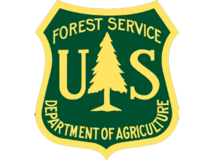 US Forest Service green and gold badge with pine tree and “Department of Agriculture” text