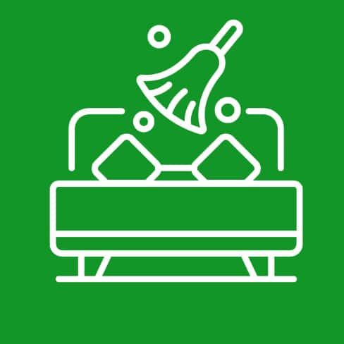 White line icon of a person sweeping a bed on a green background