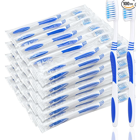 Stack of blue-and-white disposable toothbrushes with two standing upright