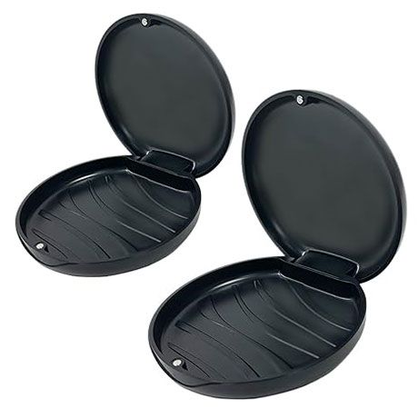 Two black oval clamshell cases open to show ribbed interiors, side by side on a white background