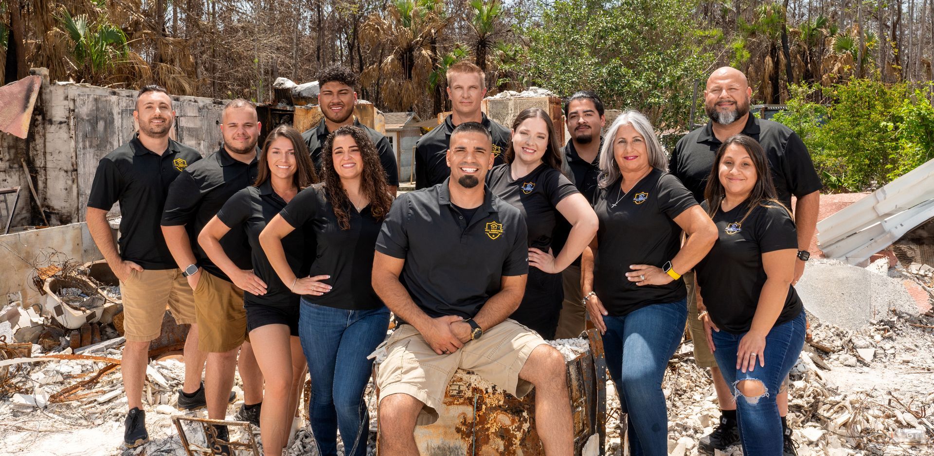 A group of people in black shirts are posing for a picture.