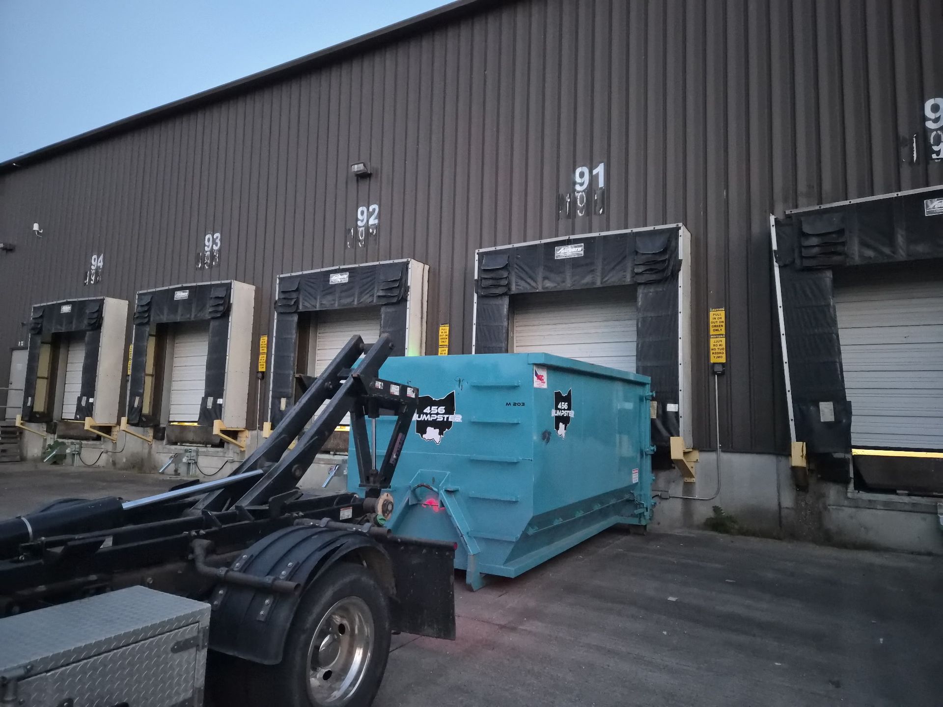 dumpster at warehouse featuring 456 dumpster logo