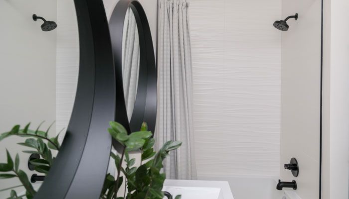 A bathroom with two sinks , a bathtub and a shower.